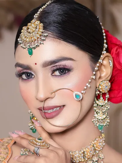 A smiling shot that shows the makeup in a more natural, candid moment. The student has balanced a bold eye with a sophisticated lip color.