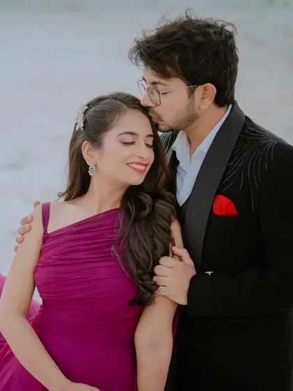 A tender kiss on the forehead, capturing a moment of pure affection. The close-up framing focuses entirely on the couple's emotion and connection.