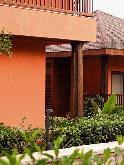 The warm, earthy tones of our resort's architecture are complemented by the vibrant green of the surrounding gardens, creating a visually pleasing and calming environment.