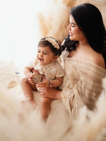 A close-up shot capturing the giggles and joy between a mother and her baby.