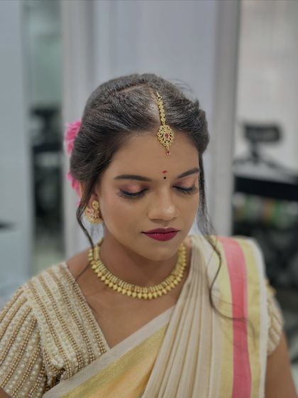 A close-up on the makeup, showing the soft yet defined eye makeup and lip colour that completes this timeless bridal look.