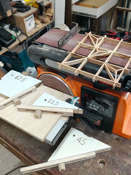 Here are some of my new jigs for making Kumiko infill pieces, sitting next to a disc sander. Creating specialized tools like these is part of my Level Up workshop, allowing for more complex projects.