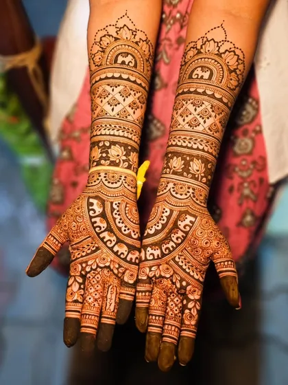 This design incorporates adorable elephant motifs marching along the forearms, a popular and auspicious choice for bridal henna.