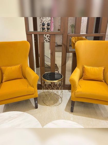 Another shot of the elegant high-back chairs in yellow velvet, showcasing their clean silhouette and comfortable design.
