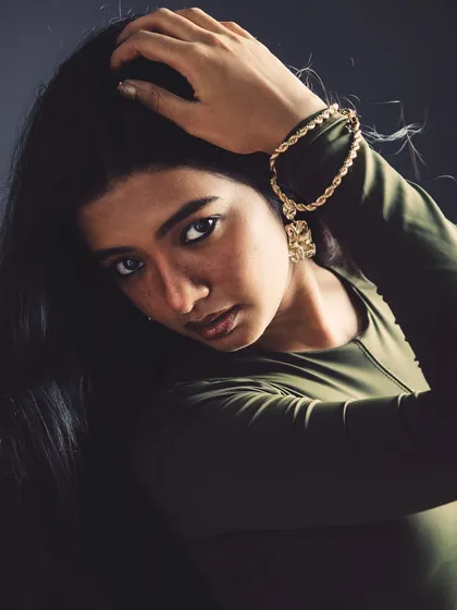 A portrait that emphasizes the model's striking features and beautiful long hair. The pose is simple but confident.