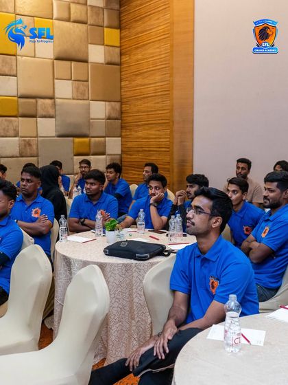 Our coaches fully engaged during a classroom session. Continuous learning is a core part of our culture, ensuring we always bring the best to the pitch.