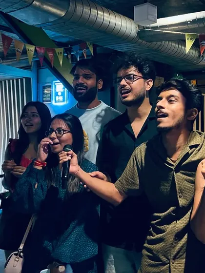It's not about being a pro, it's about the shared energy. Here, a group of friends take the stage together, turning a regular night into a core memory.
