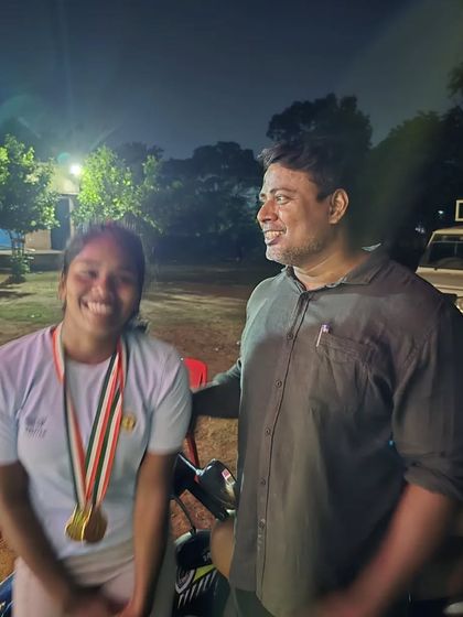 Sharing a moment of pride with a student after her victory. Her smile and her medals show the joy of achieving a hard-fought goal.