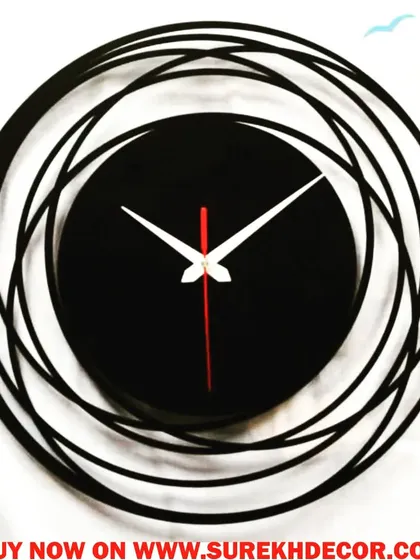 This abstract wall clock features a swirling, multi-circular frame in charcoal black. The minimalist face is centered within the dynamic design, creating a piece that feels like a modern sculpture.