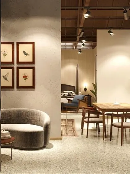 A quiet corner of the store designed as a reading nook or small seating area. The curved sofa and warm lighting create an intimate and inviting space for customers to pause and relax.