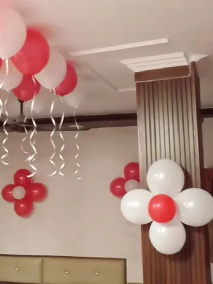 Simple balloon flower clusters in red and white are an easy way to add a festive touch to walls and pillars for a birthday party.