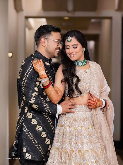 A beautiful portrait of the couple sharing a quiet moment, with the bride's intricate lehenga and the groom's stylish kurta on full display.