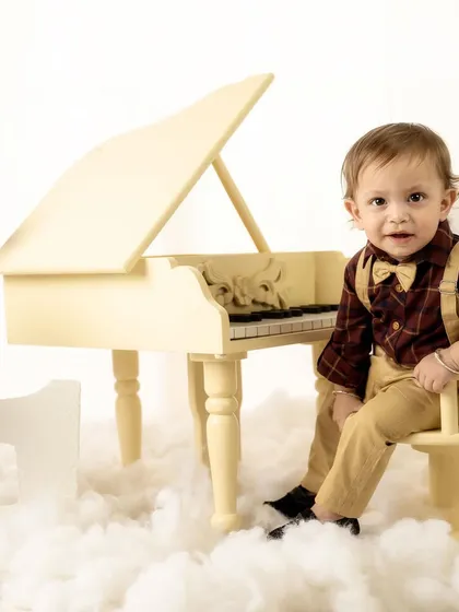 This little gentleman looks so sharp with his bow tie and suspenders for his piano-themed milestone shoot.