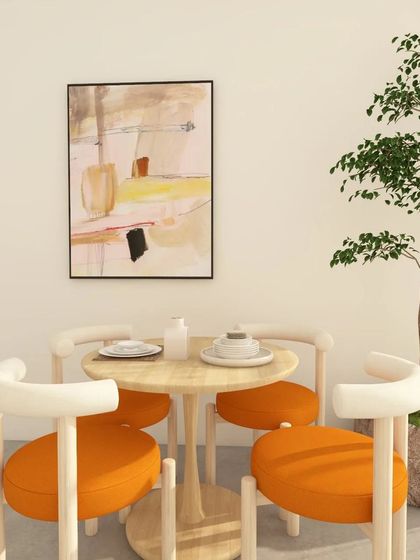 A minimal dining setup design. Adding a pop of color with bright orange upholstery on the chairs and abstract wall art brings life to a simple, clean theme.