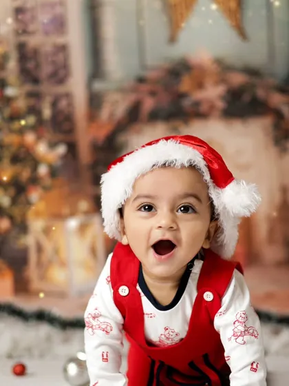 The wonder of Christmas in his eyes. This little boy is enjoying our festive setup with a Christmas tree and twinkling lights.