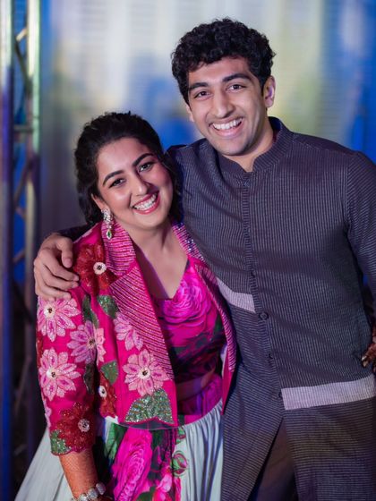 Siblings celebrating together. For this event, we styled the sister in a modern lehenga with a floral embroidered jacket and the brother in a sleek, contemporary bandhgala, showing how different styles can still feel connected.