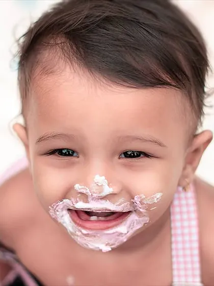 Nothing says "first birthday" quite like a cake smash. This close-up captures the messy, adorable, and hilarious reality of the moment. It’s a fun and memorable way to celebrate a huge milestone for your little one.