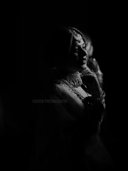 A dramatic black and white bridal portrait using shadows to create a mysterious and elegant silhouette.