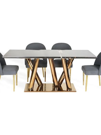 This dining set pairs a black marble top table with grey suede chairs. The table's pedestal base is asymmetrically designed with a glossy PVD finish, creating a modern and dynamic look.