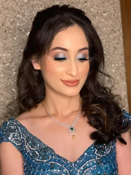Rashvita's eyes closed to showcase the full effect of the shimmery blue eyeshadow.
