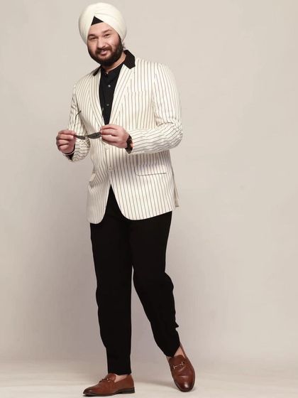 Another pose in the white pinstripe blazer, showing its versatility and modern appeal. A great rental choice for a unique party look.