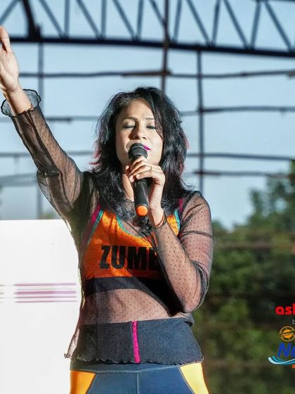 A moment of calm before the energy explodes. On stage at the IPA Neerathon, I take a deep breath to inhale appreciation and exhale any doubts. It's all about bringing love, light, and positive vibes to the runners.