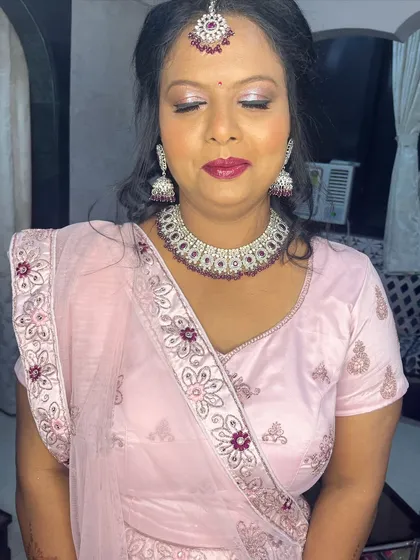 A close-up of the glamorous makeup, with a focus on the silver and pink eyeshadow and deep berry lipstick.