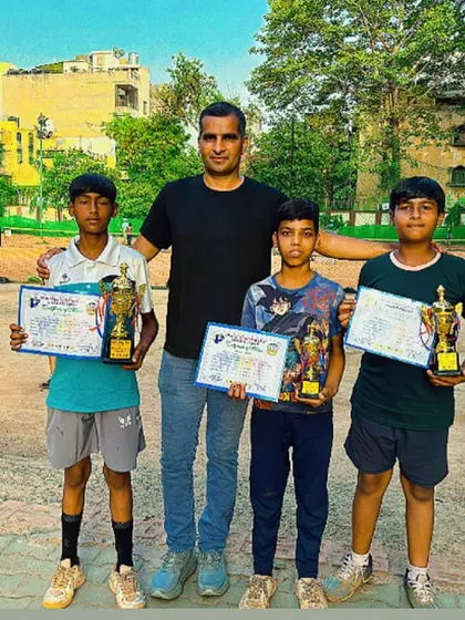 Champions Ansh, Satish, and Naman with their coach and their trophies. I am proud of their performance and their winning attitude on the court.