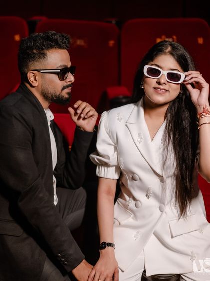 A cool and playful close-up of a couple with 3D glasses in a movie theatre. This shot captures their fun personalities and the unique, cinematic theme of their pre-wedding shoot.