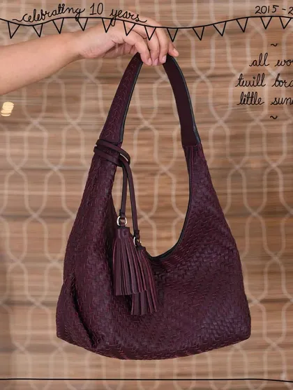 The Little Sunaina hobo bag, shown here in our All Woven Twill Bordeaux style. The entire body is hand-woven, and the handle features our signature twilling detail, making it a beautifully textured and artisanal piece.