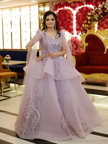 A dreamy lilac-colored gown with tiered layers and delicate silver embroidery. This rental is perfect for a reception or engagement party where you want a soft, romantic, and modern look.
