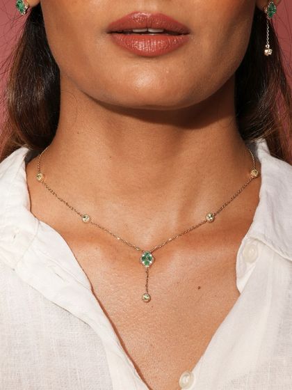 The Green Meadow lariat necklace worn by a model, showing its delicate and flattering design.
