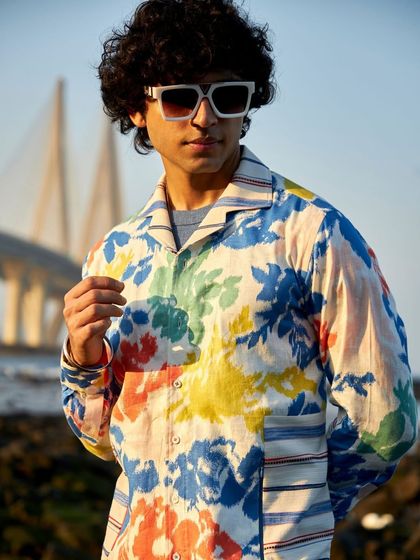 Awaken an aura of understated elegance. This vibrant floral printed shirt, shown here with the sea link in the background, is a testament to luxury where form meets function.