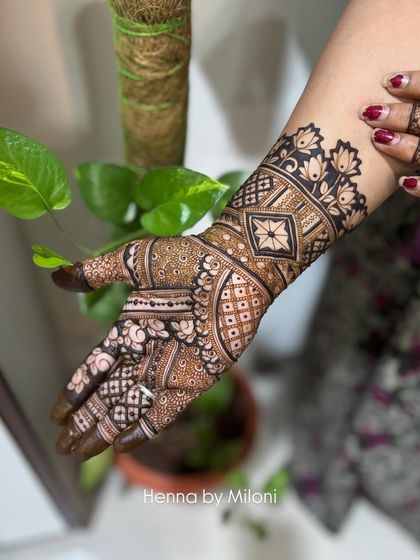 A beautiful example of a non-bridal intricate design, with a mix of geometric and floral patterns covering the hand and wrist.