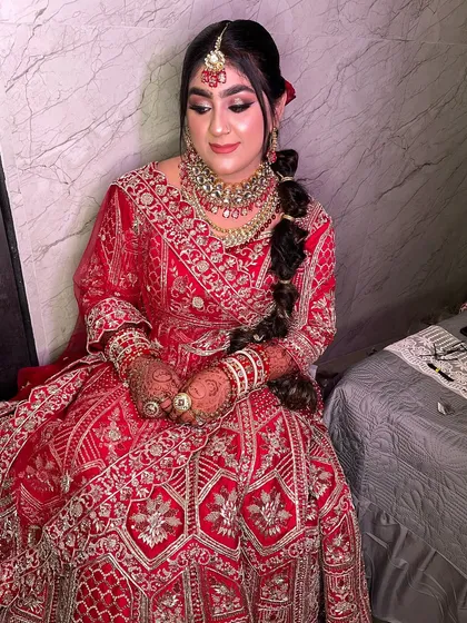 My stunning bride in her full red lehenga. The complete look is a perfect blend of tradition and glamour, making her look and feel like a queen.