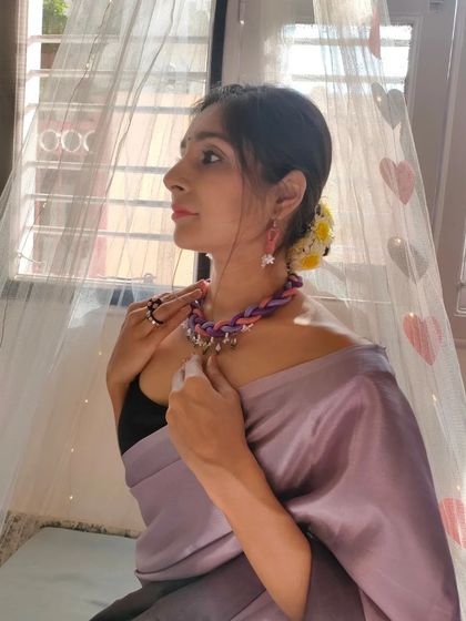 Here I am modeling the braided thread necklace, showing how it can elevate a simple saree. The combination of colors and textures makes it a versatile accessory.