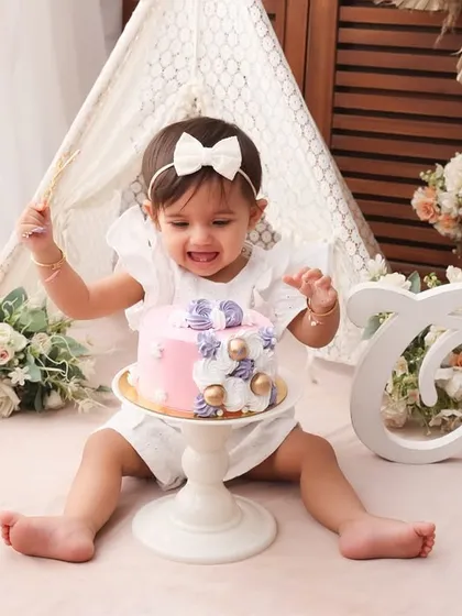 Pure excitement! The joy on her face as she gets ready to dive into her cake is priceless. My goal is to capture these expressions of pure, uninhibited happiness.