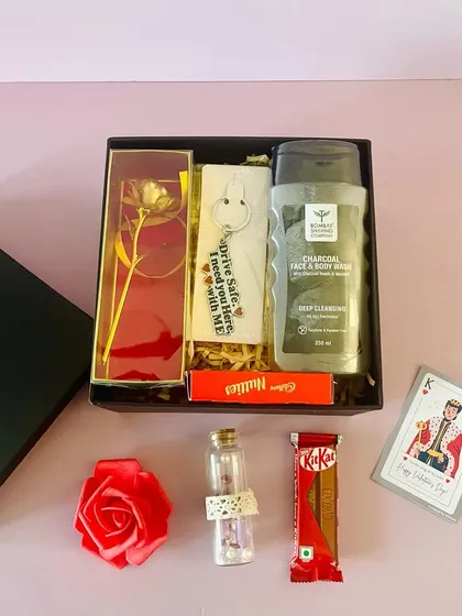 Another affordable Valentine's option for him. This black box contains a charcoal body wash, a golden rose, a keychain, and chocolates.