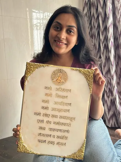 A happy client holding her custom-made Navkar Mantra frame. I love creating pieces that bring joy and peace to a home.