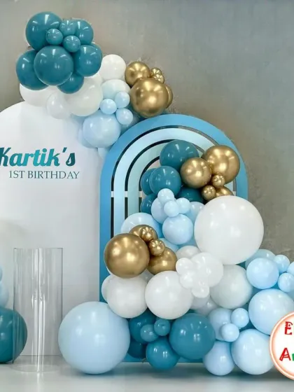 Another angle of the elegant blue, white, and gold balloon decor for Kartik's first birthday.