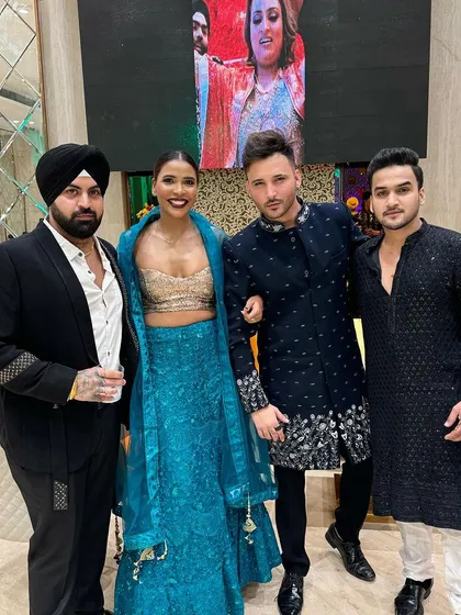 A group shot of stylish wedding guests. Our clients are wearing a variety of our custom designs, from a black suit to embroidered Indo-Westerns.