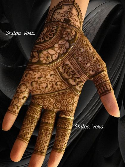 A close-up of a very detailed design, showing fine lines, dots, and swirls that fill the entire palm.