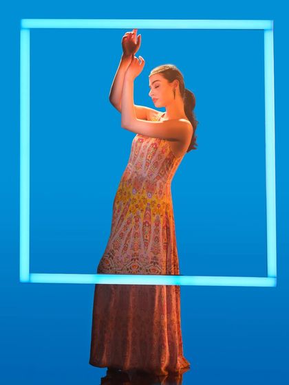 A creative lighting setup using a glowing frame. In our workshops, we experiment with unconventional light sources to create unique, graphic, and memorable fashion images like this one.