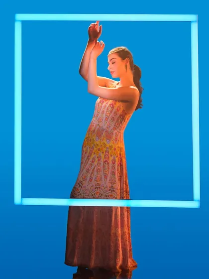 A creative lighting setup using a glowing frame. In our workshops, we experiment with unconventional light sources to create unique, graphic, and memorable fashion images like this one.