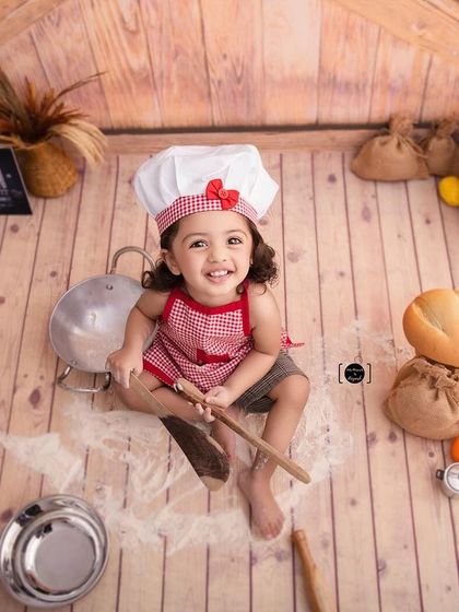 An aerial view of little chef Iba at work, surrounded by props and ingredients, making for a dynamic and playful shot.