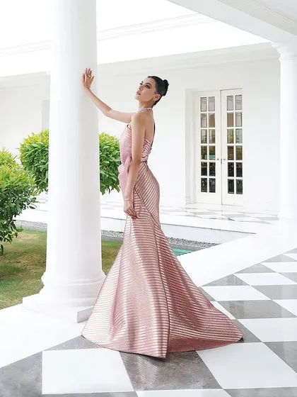 This angle highlights the sleek, body-hugging fit of the metallic pink Amit Aggarwal gown. My focus is always on "Fit > Label," ensuring the silhouette is perfect for the client.