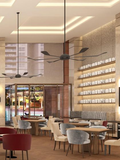 A digital render of the Elevate Clubhouse dining area, showcasing the intended ambiance with its double-height space, large fans, and sophisticated material palette before construction.