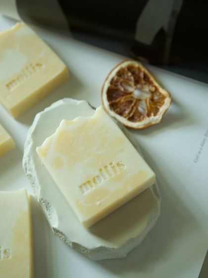 My Orange & Bergamot soap on a handmade dish, perfect for a zesty morning shower.