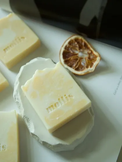 My Orange & Bergamot soap on a handmade dish, perfect for a zesty morning shower.