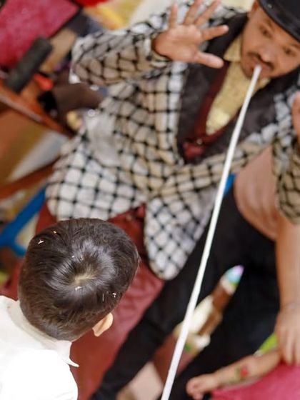 Even at a superhero party, a little magic is always a hit. A magician performs an amazing trick for the birthday boy and his friends, adding another layer of entertainment to the day.